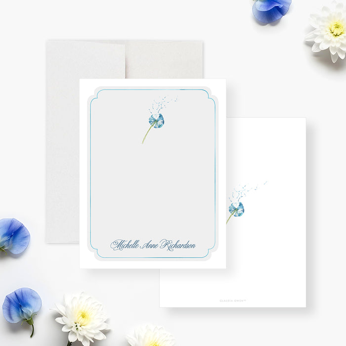Personalized blue floral memorial thank you card with delicate dandelion flower, pale blue border, and custom name-front-back