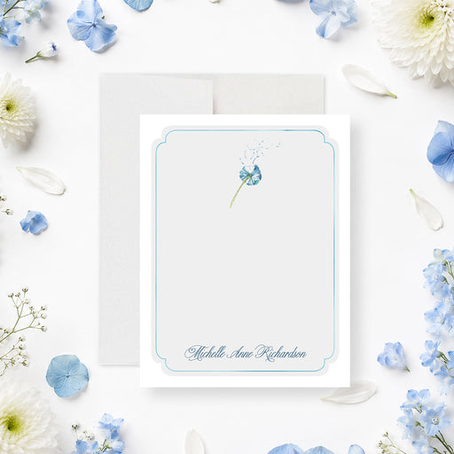 Personalized blue floral memorial thank you card with delicate dandelion flower, pale blue border, and custom name-front