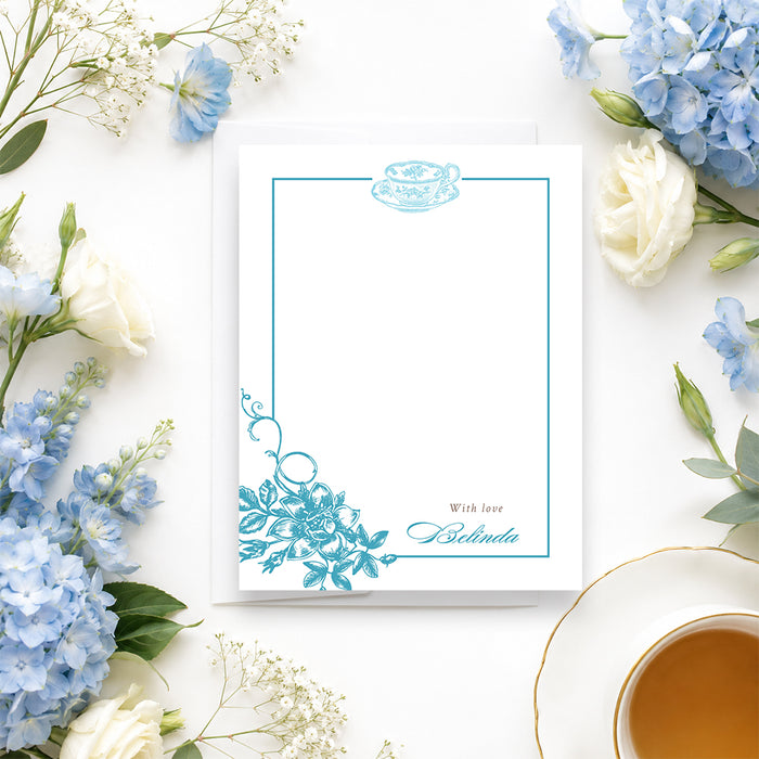 Personalized blue floral tea party note card with teacup illustration, botanical border, and custom name-front