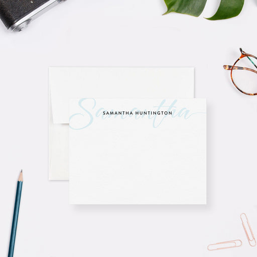 Personalized note card with a light blue script initial and a personalized name, shown with a white envelope.