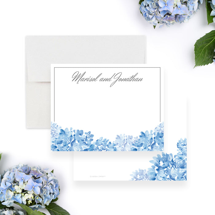 Personalized blue watercolor hydrangea wedding note card with couple’s names in gray script, a thin border, and blue flowers along the bottom-front-back