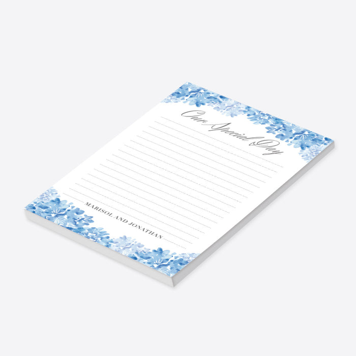 Personalized wedding notepad with blue watercolor hydrangeas, lined white writing area, Our Special Day heading, and couple’s names-side