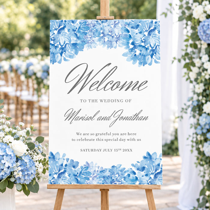 Personalized blue watercolor hydrangea wedding welcome sign with gray script lettering, couple’s names, wedding date, and floral borders displayed on an easel