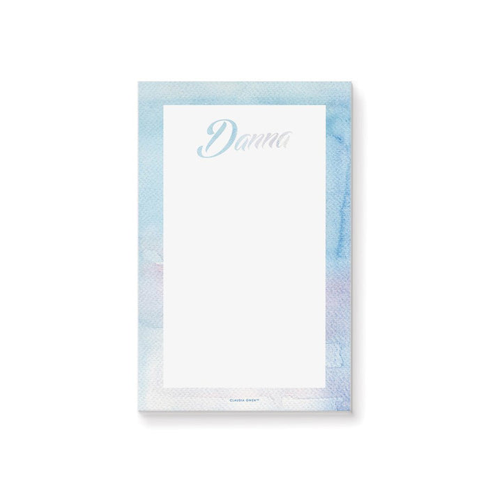 personalized blue watercolor notepad with custom name in script lettering, soft watercolor border, and blank writing space