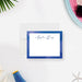 Personalized note card with a white writing area with a blue watercolor border and a name in script. Shown with a white envelope.
