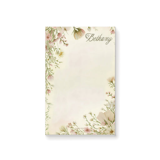 Personalized blank notepad with Bethany name, blush pink, cream and pale yellow wildflowers and a delicate leafy botanical border