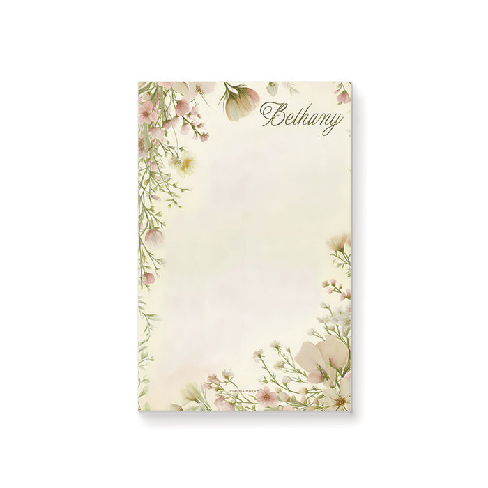 Personalized blank notepad with Bethany name, blush pink, cream and pale yellow wildflowers and a delicate leafy botanical border