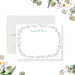 Personalized note card with a white front with a delicate botanical border and a personalized name in pale blue-green script. Shown with a white envelope.
