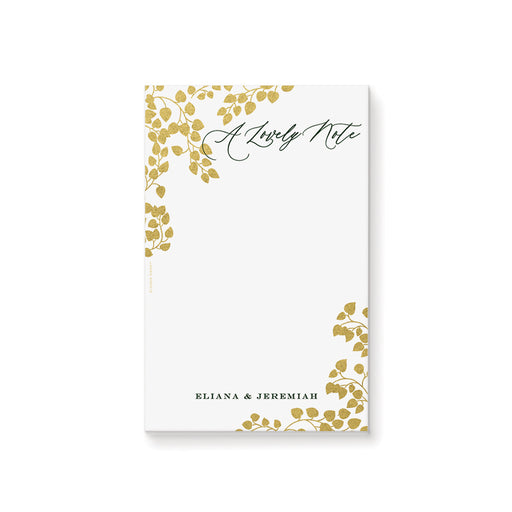 Personalized blank botanical notepad with A Lovely Note wording, gold-colored leaf vines and custom couple’s names
