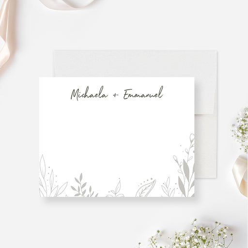 personalized botanical wedding thank you card with couple names, delicate foliage line art, white front, and moody green back design-front
