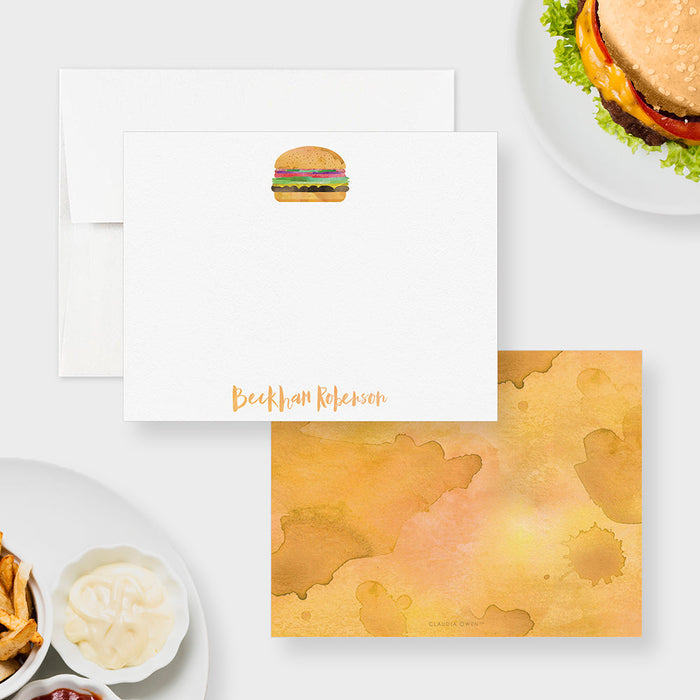 Front and back of personalized note cards with a watercolor cheeseburger illustration and a personalized name and a warm yellow watercolor patterned back.