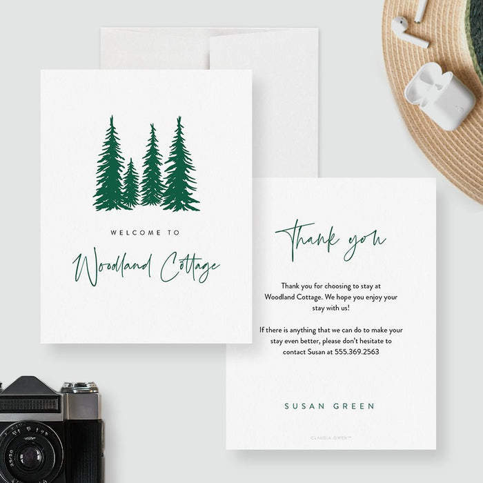 Cabin welcome card with green pine trees and a custom property name on the front; guest message, host name and contact details on the back.