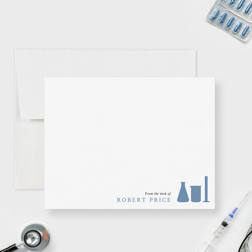 Personalized chemistry note card with blue flask, beaker and test tube illustrations beside the name at the lower right on white.