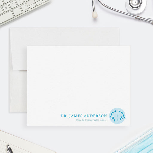 Personalized chiropractor note card with a blue spine icon, practitioner name and clinic wording at the bottom of a white front.