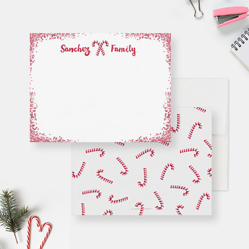 White personalized Christmas note card with a red dotted border and candy canes, beside a red candy cane-patterned back.