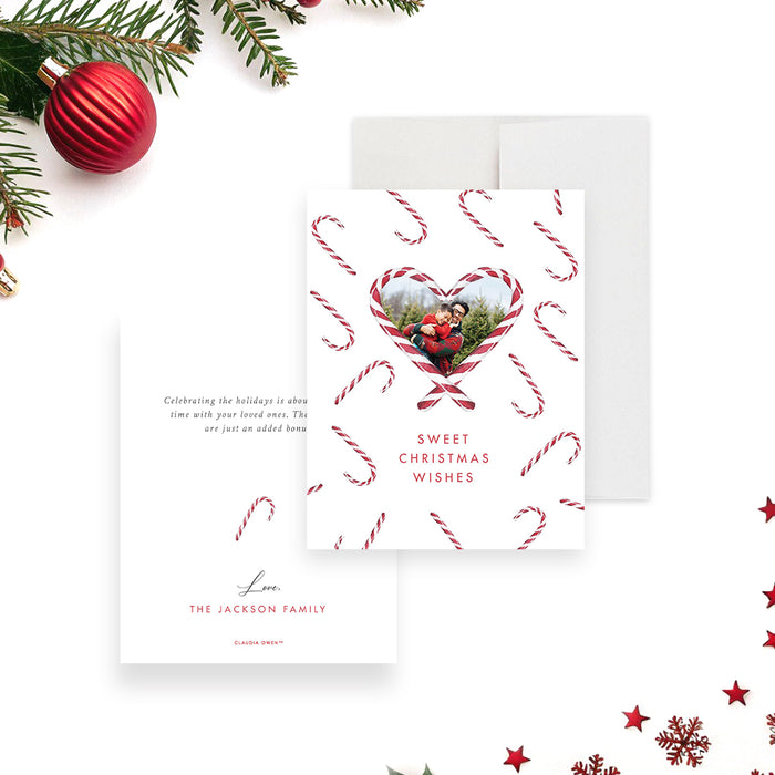 Personalized holiday greeting card featuring a family photo inside a heart-shaped candy cane frame with festive candy cane pattern, and sweet Christmas message-front-back