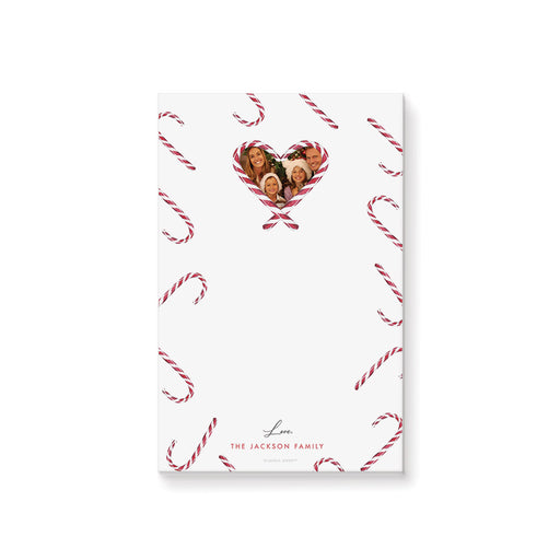 Personalized Christmas notepad with candy cane pattern, heart-shaped family photo, and custom family name.