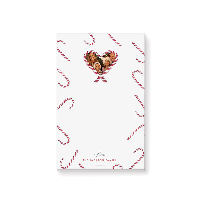 Personalized Christmas notepad with candy cane pattern, heart-shaped family photo, and custom family name.