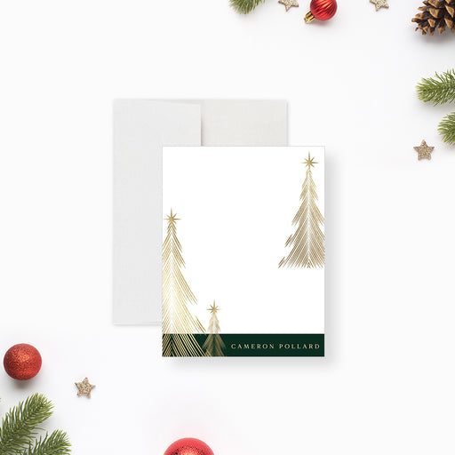 Personalized Christmas note cards with printed gold tree illustrations on the white writing front and a dark green tree patterned reverse.