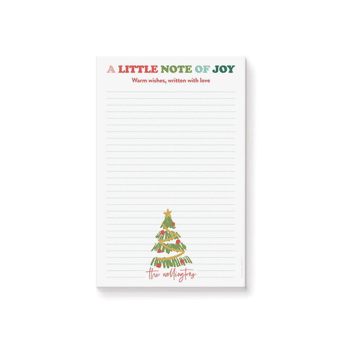 Personalized Christmas notepad featuring a hand-drawn Christmas tree, colorful holiday heading, lined writing space, and a custom family name.