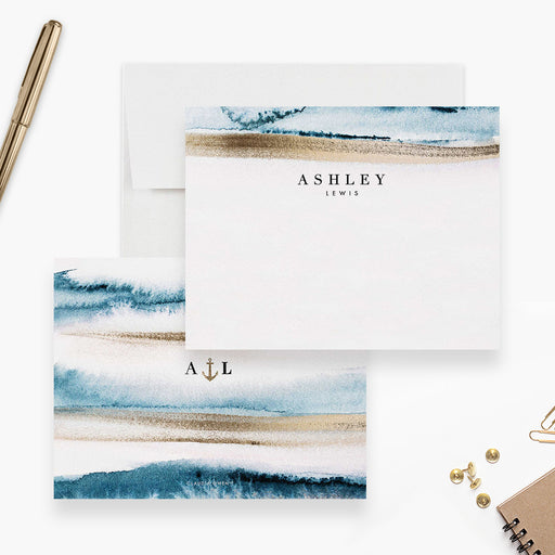 Personalized coastal note cards with blue and sandy beige watercolor bands, a name on the white front and initials on the reverse.