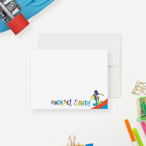 White personalized skateboard note card with colorful name lettering and skateboard artwork, beside a bright skateboard-patterned back.
