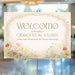 Personalized garden wedding welcome sign with colorful meadow wildflowers, arched vine border, couple’s names and wedding date