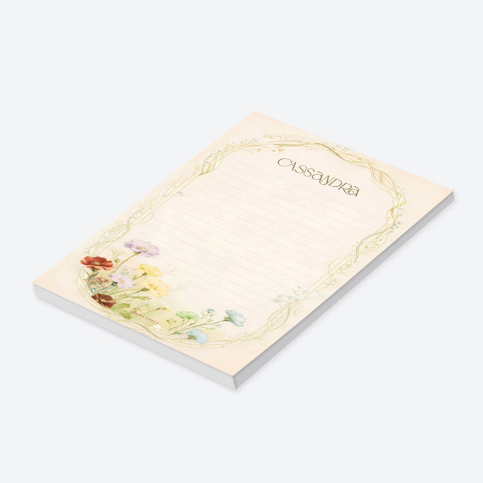 Personalized lined notepad with Cassandra name, delicate arched vine border and colorful red, yellow, blue and lavender wildflowers-side