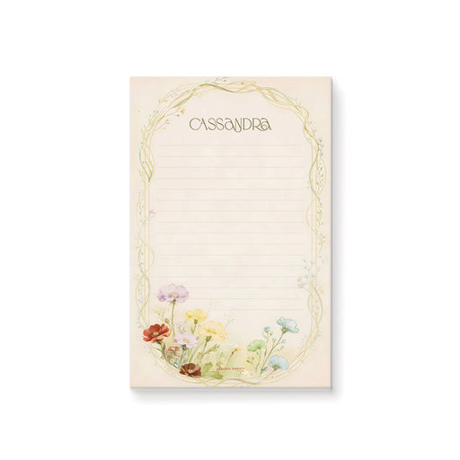 Personalized lined notepad with Cassandra name, delicate arched vine border and colorful red, yellow, blue and lavender wildflowers