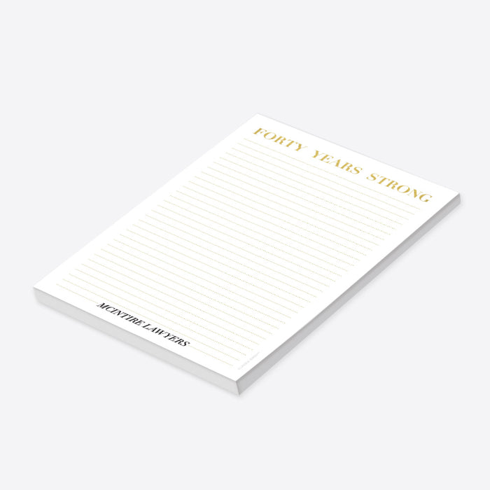 personalized corporate anniversary notepad with Forty Years Strong heading, gold-colored lines, and custom company name-side
