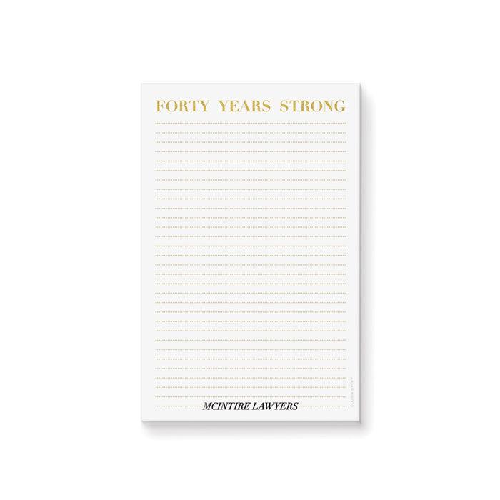 personalized corporate anniversary notepad with Forty Years Strong heading, gold-colored lines, and custom company name