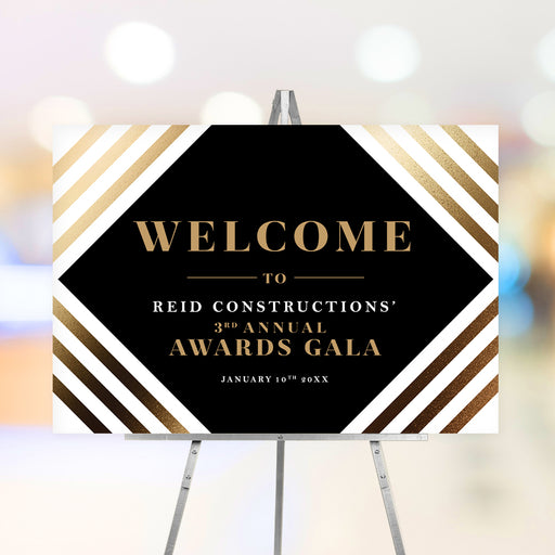 Personalized corporate awards gala welcome sign with black geometric center, warm striped border, company name and annual event date