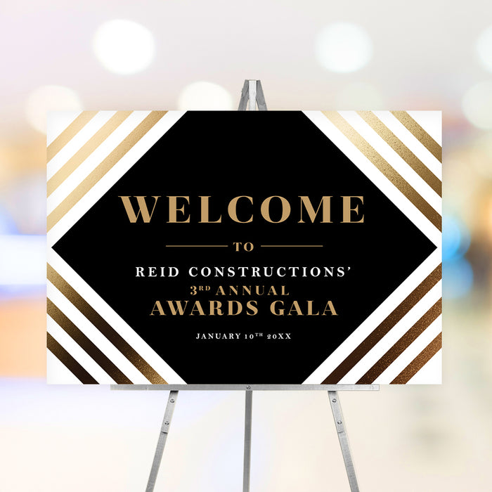 Personalized corporate awards gala welcome sign with black geometric center, warm striped border, company name and annual event date
