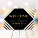 Personalized corporate awards gala welcome sign with black geometric center, warm striped border, company name and annual event date