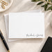 Minimalist personalized couples note card with two names in black script at the lower right, shown with a white envelope-front