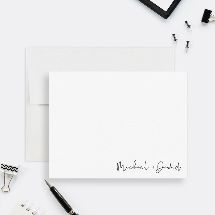 Minimalist personalized couples note card with two names in black script at the lower right, shown with a white envelope-front