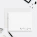 Minimalist personalized couples note card with two names in black script at the lower right, shown with a white envelope-front