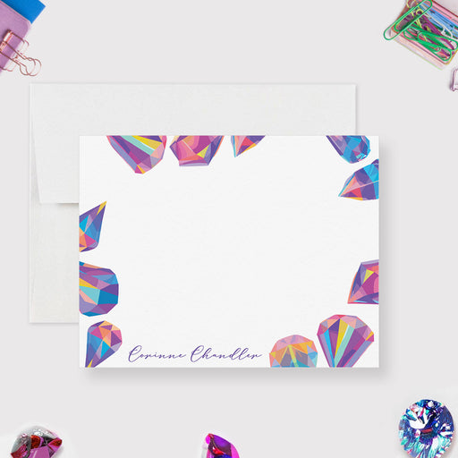 Personalized crystal note card with colorful printed gemstone illustrations around a white front and a script name along the bottom.