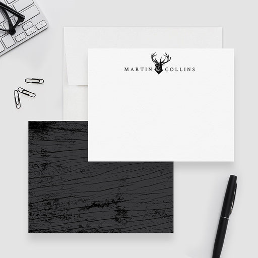 Personalized white note card with a black deer head and antlers and a dark wood grain patterned reverse.