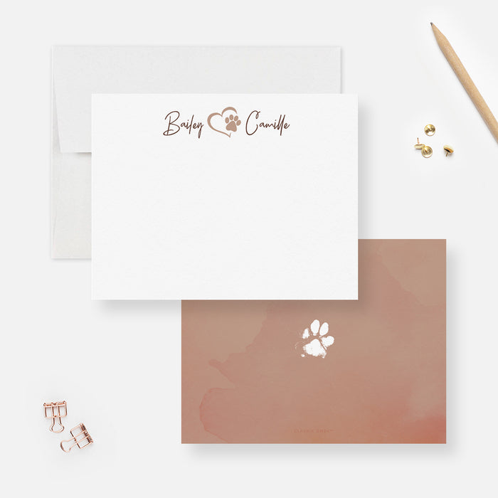 White personalized note card with a small paw and heart detail, beside a brown watercolor back featuring a white paw print.