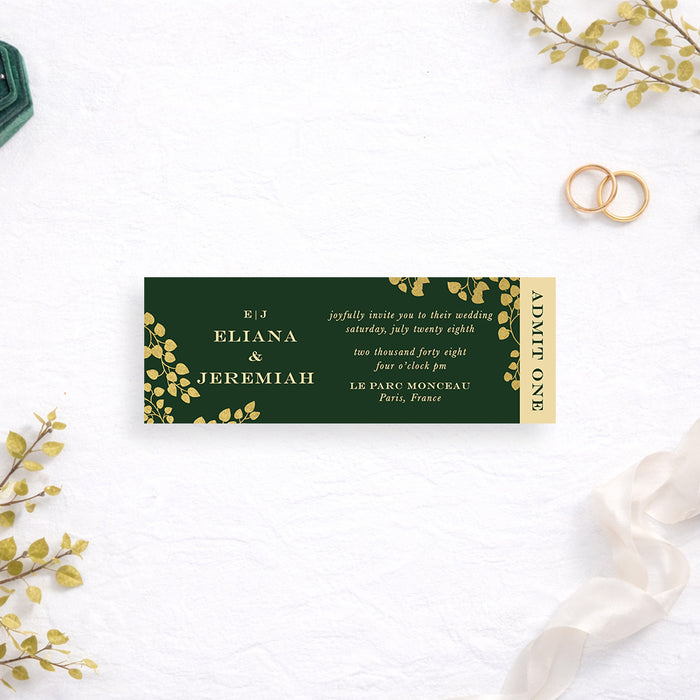 Personalized emerald green wedding ticket invitation with gold-colored leaf vines, couple’s monogram, custom names, event details and vertical Admit One wording