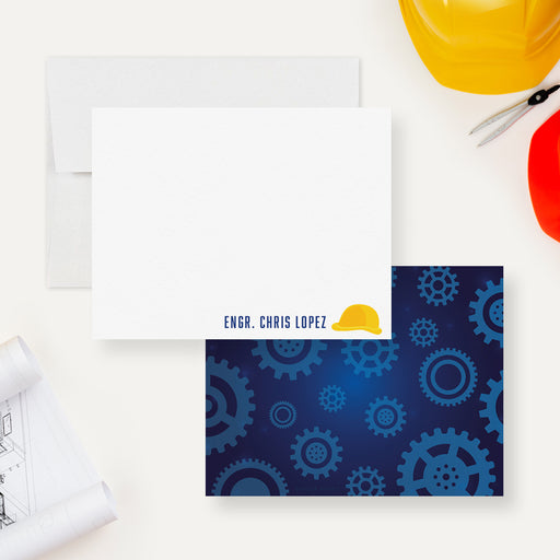 White personalized engineering note card with a yellow hard hat, beside a dark blue back patterned with blue gears.