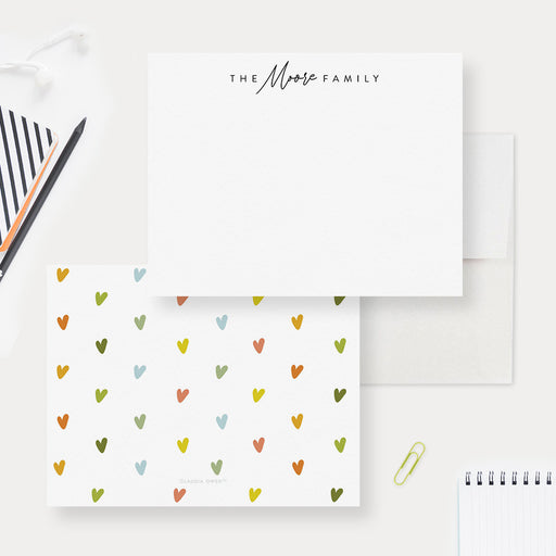 Personalized family note cards with a family name on the white front and tiny colorful hearts on the reverse.