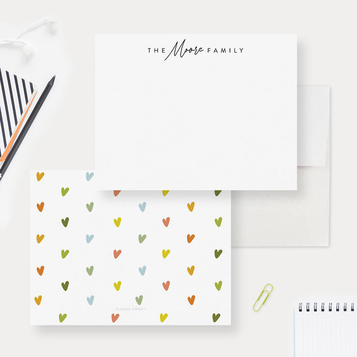 Personalized family note cards with a family name on the white front and tiny colorful hearts on the reverse.