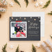 Personalized family photo holiday card with a winter sledding photo, cream snowflakes and Happy Holidays greeting on a charcoal background-front