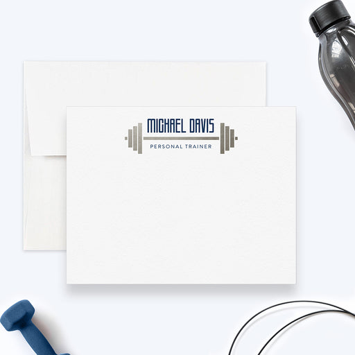 Personalized fitness trainer note card with a navy name and trainer wording framed by a gray barbell at the top of a white front.
