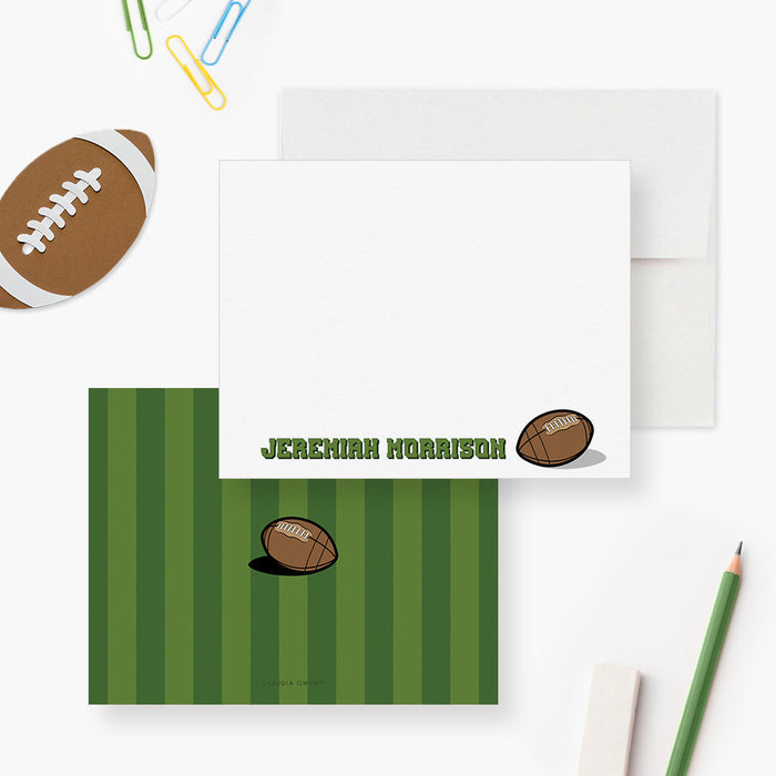 Front and back of personalized note cards with an American football illustration and a name in green lettering and a green football field patterned back.