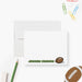 Personalized note card with an American football illustration and a name in green lettering, shown with a white envelope.