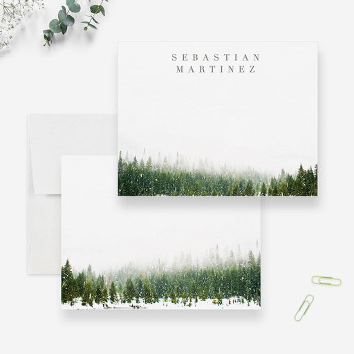 Personalized white note cards with a green winter forest border along the bottom of the front and reverse.