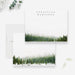 Personalized white note cards with a green winter forest border along the bottom of the front and reverse.